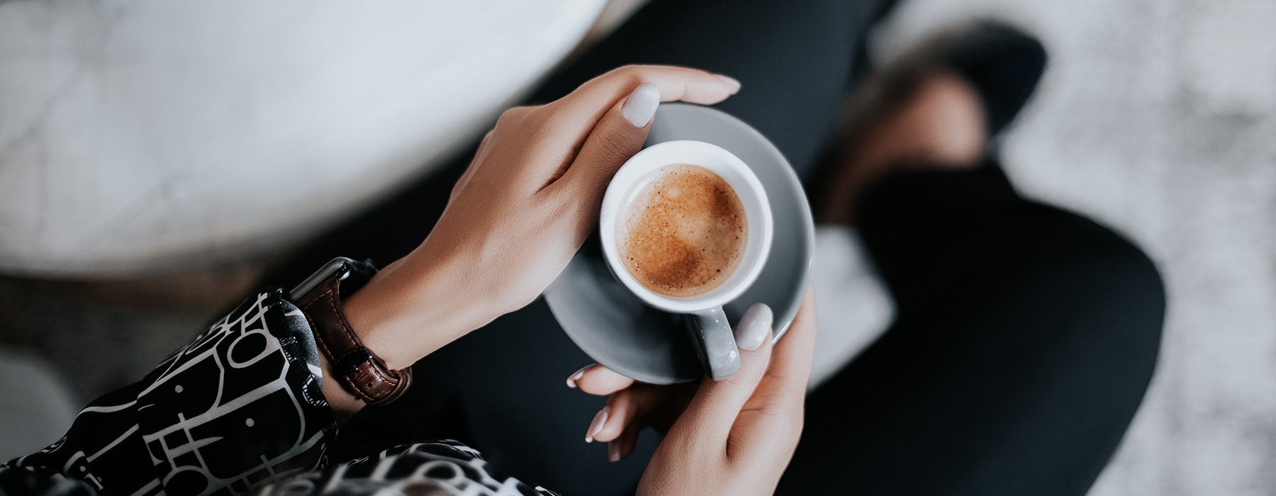 overhead view of a woman holding a mug of coffee