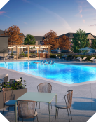poolside with chairs and tables near 